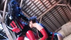 Latex fetish lovers Sandra and Diana lick and toy on the ground of a barn