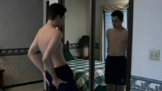 Playful city boy Carrigan does a strip tease in front of the mirror and masturbates in bed